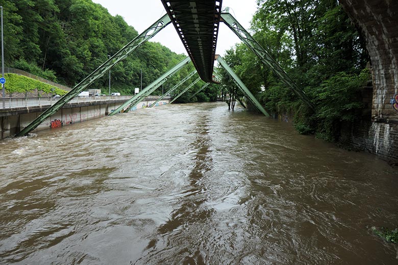 Wupper mit Hochwasser am 15. Juli 2021 unterhalb der Sonnborner Brücke, über die die Eisenbahngleise führen